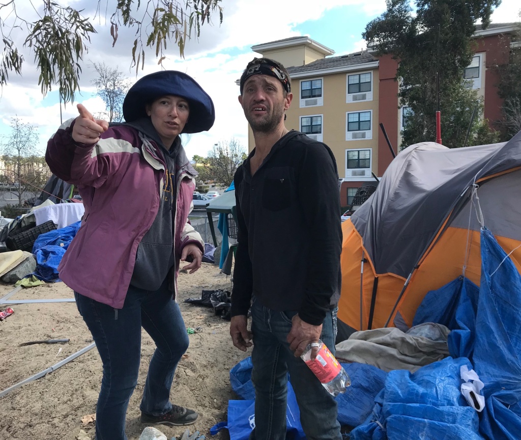 OC riverbed homeless Brooke Weitzman, a lawyer for the homeless, urges riverbed resident Scott Henderson to pack up so he can go spend the night at a motel.