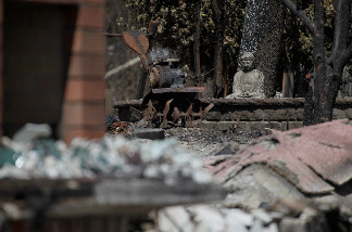 File photo: A charred buddah statue sits in the yard of a home that was destroyed by fire following a deadly gas main explosion on September 13, 2010 in San Bruno, California.