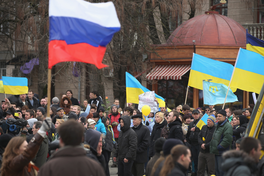 Pro-Russian marchers (foreground) walk past pro-Ukrainian marchers Pro-Russian marchers (foreground) walk past pro-Ukrainian marchers gathered in Simferopol, capital of Ukraine's Crimea region, Saturday. Several hundred pro-Ukrainian protesters marched peacefully through the city center to a Ukrainian military base that's been blockaded by pro-Russian militants and soldiers.