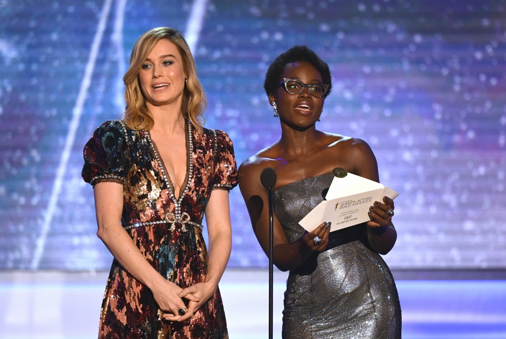 US-ENTERTAINMENT-SAG-FILM-AWARDS-SHOW Brie Larson (L) and Lupita Nyong'o present the award for outstanding performance by a cast in a motion picture during the 24th Annual Screen Actors Guild Awards show at The Shrine Auditorium on January 21, 2018 in Los Angeles, California.