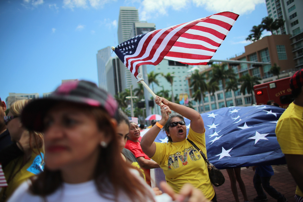 Maglena Gomez waves an American flag as she and others participate in a march that organizers said was an attempt to get the U.S. Congress to say yes to immigration reform on April 6, 2013 in Miami, Florida. Maglena Gomez waves an American flag as she and others participate in a march that organizers said was an attempt to get the U.S. Congress to say yes to immigration reform on April 6, 2013 in Miami, Florida.