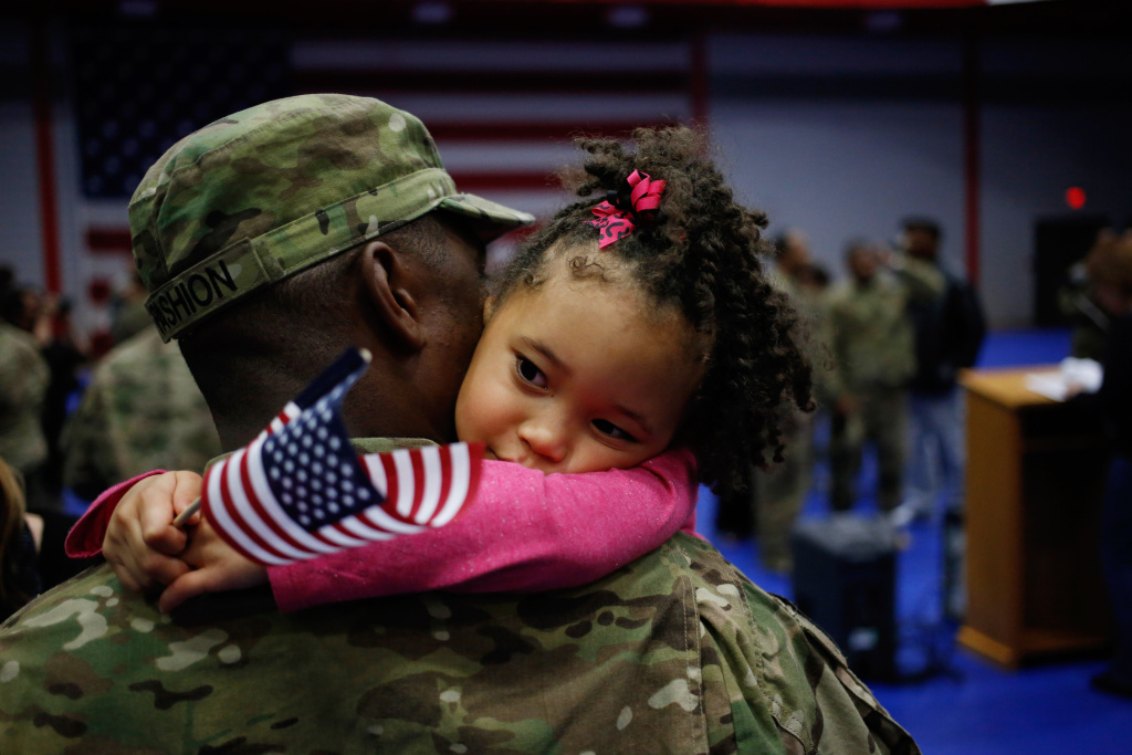 Soliders From Army's 3rd Brigade Return Home From Afghanistan To Fort Knox Spc. Michael Fashion of the U.S. Army's 3rd Brigade Combat Team, 1st Infantry Division, holds his daughter Malia Banks, 5, following a homecoming ceremony in the Natcher Physical Fitness Center on Fort Knox in the early morning hours of Wednesday, November 20, 2013 in Fort Knox, Ky.