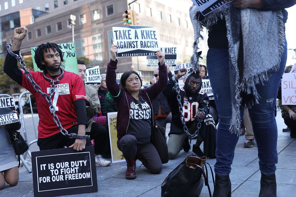 Activists Protest Outside NFL Fall League Meeting In New York A coalition of advocacy groups 'take a knee' outside of a hotel where members the quarterly NFL league meetings are being held on October 17, 2017 in New York City.