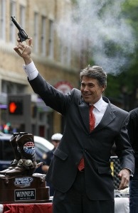 Mercer 20871 Texas Governor Rick Perry fires a six-shooter pistol in downtown Fort Worth during a promotional event with Texas Motor Speedway on April 15, 2010 in Fort Worth, Texas.