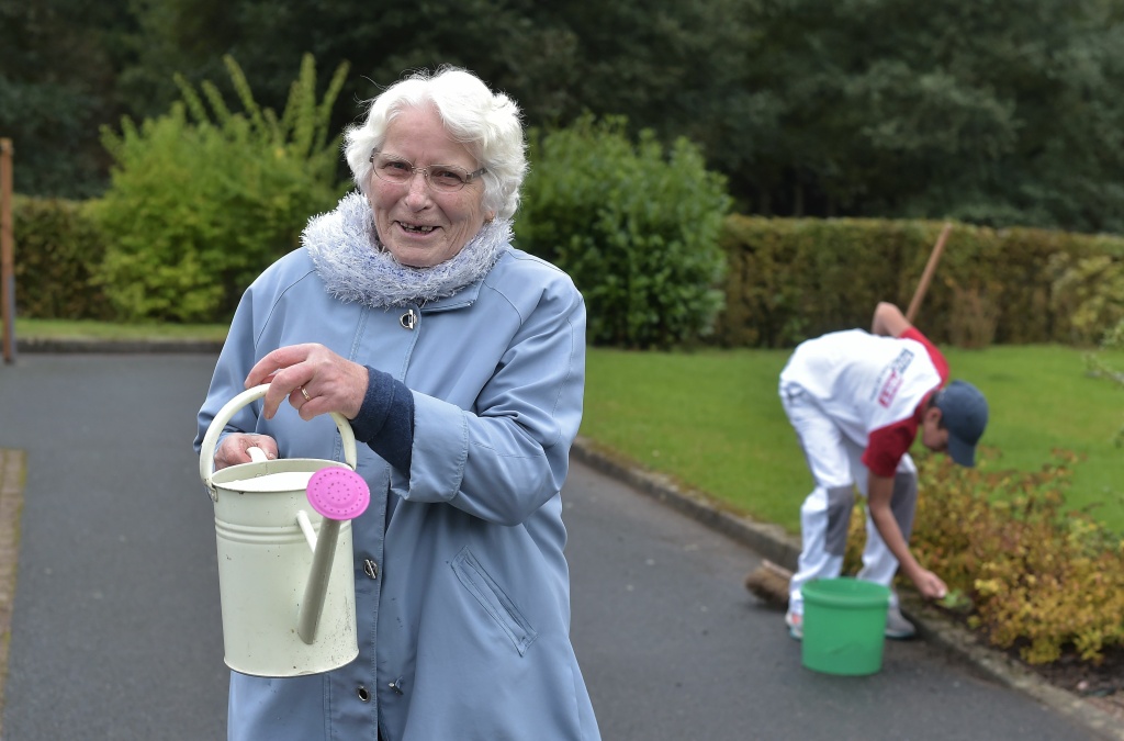 FRANCE-HEALTH-EDUCATION-ALZHEIMER A woman with Alzheimer's disease holds a watering can in the garden of a retirement home on October 18, 2016 in Saint Quirin, France.