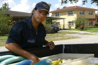 Yoelvis Bengochea cleans pools for for his family business until he can land a job as an air traffic controller.