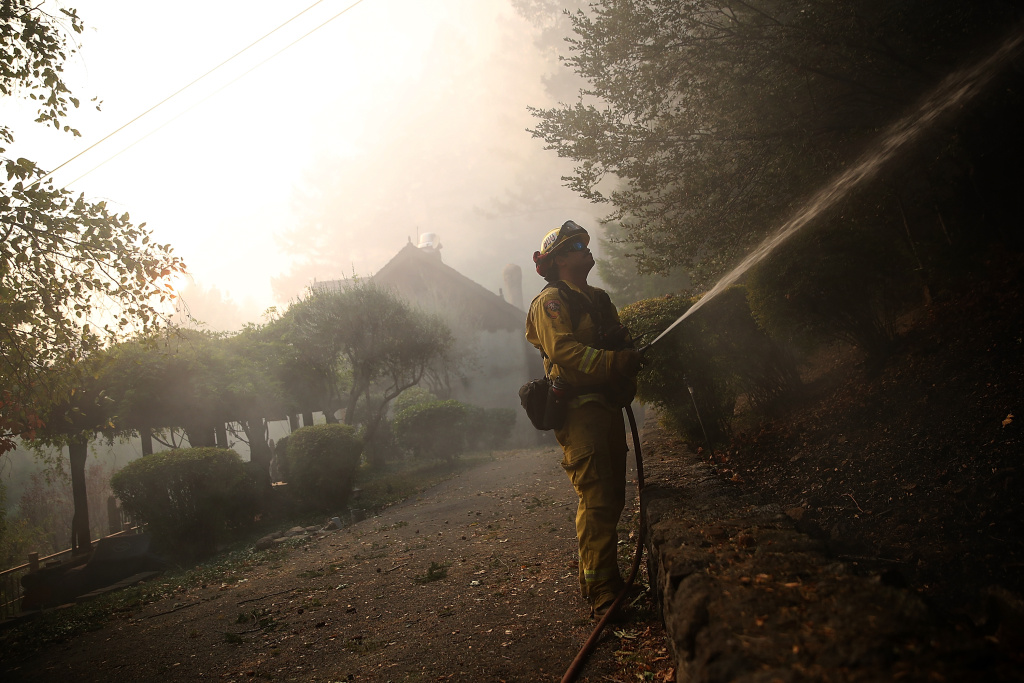 Multiple Wildfires Destroy Homes, Threaten California Wine Country A CalFire firefighter uses a hose to battle the Tubbs Fire on October 12, 2017 near Calistoga, California.