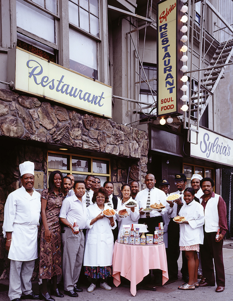 sylviawoodsstaff_fig72_enl-fc1be5a893166582ccef90201375869eeb273be8-s1400.jpg Sylvia Woods and her employees outside Sylvia's restaurant, a legendary soul-food restaurant in Harlem.