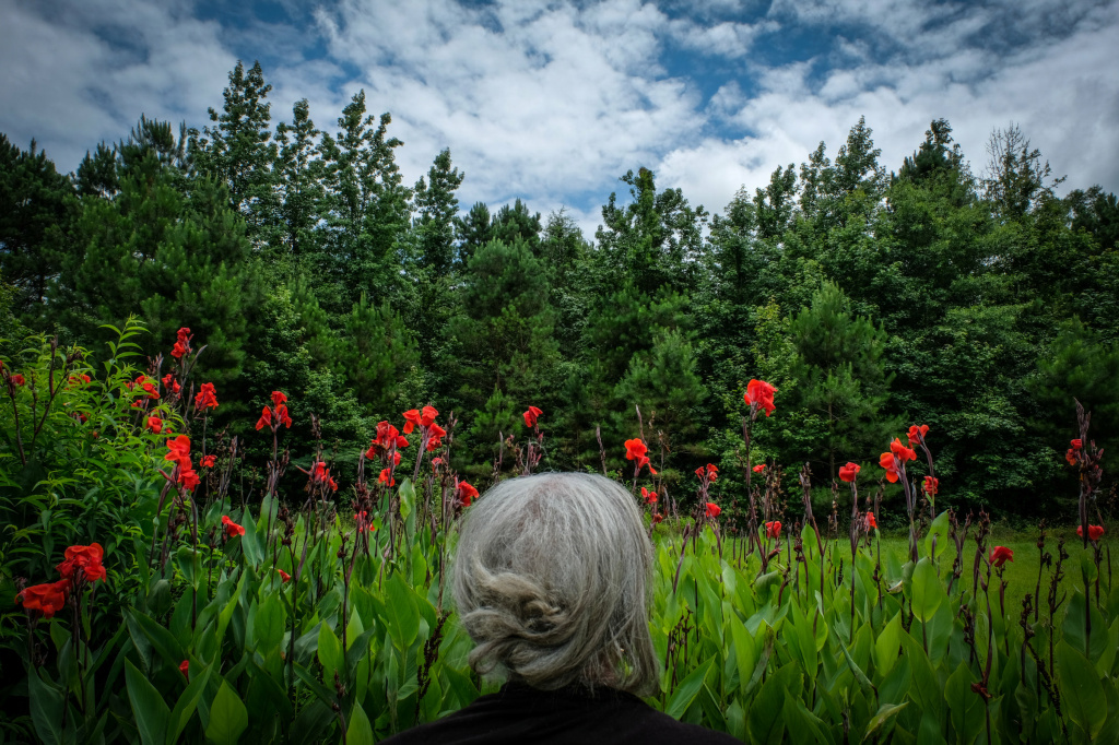 Instagram photographer The photographer's aunt Jean stands in front canna lilies in Dalark, Arkansas.