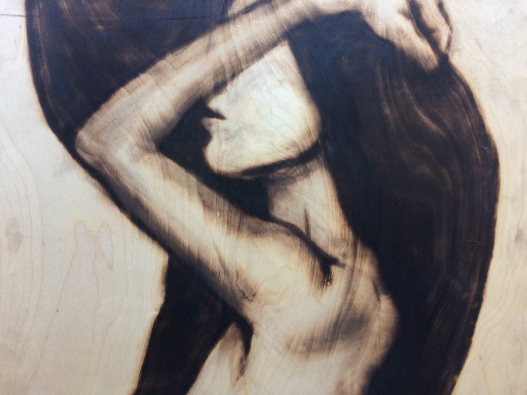 A detail of one of Aronson’s portraits reveals how he incorporates the wood grain of each individual slab into his composition. A detail of one of Aronson’s portraits reveals how he incorporates the wood grain of each individual slab into his composition.