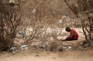 Mercer 19990 A refugee child sits on the outskirts of the Dagahaley refugee camp which makes up part of the giant Dadaab refugee settlement.