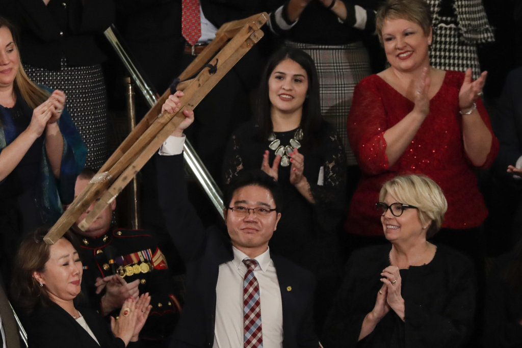 State Of Union Ji Seong-ho holds up his crutches after his introduction by President Trump during the State of the Union address on Tuesday.