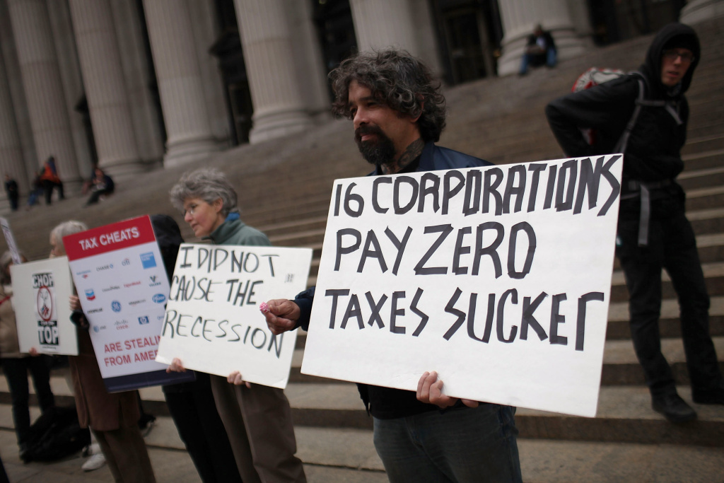 Last-Minute Tax Filers Submit Returns At 11th Hour Protesters against American corporate tax loopholes demonstrate outside of the James A. Farley Main Post Office in New York City. Taxes have been more politicized than usual this year due to revelations that some major banks and companies have not had to pay taxes for years despite making millions in profits.