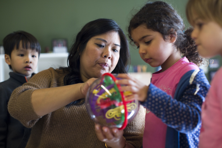 Clara, a student in the six to 18-month-old class at Caltech's Children's Center, plays by dropping balls down a tube on Wednesday morning, Jan. 21. The school has made engineering a focus in curriculum.