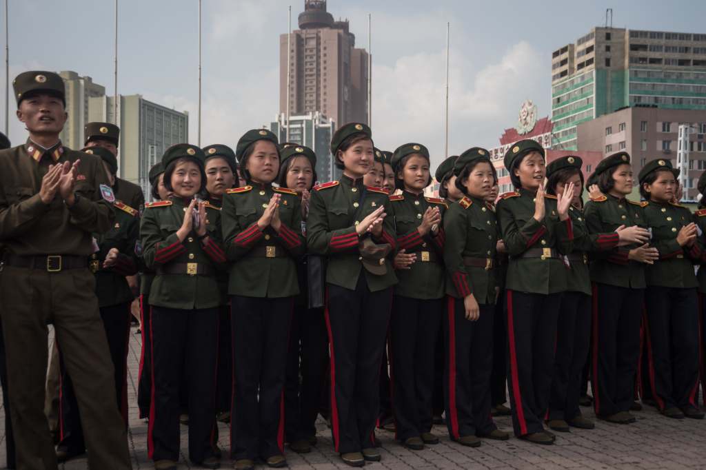 MISSILE-NKOREA-SKOREA-JAPAN-US-DIPLOMACY Korean People's Army (KPA) soldiers applaud as they watch a screen showing news coverage of an August 29 missile test launch, in a public square outside a train station in Pyongyang, North Korea on August 30, 2017.