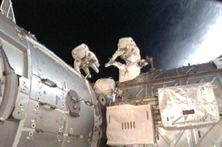 Mission Specialists Nicholas Patrick and Robert Behnken work outside the International Space Station during the second spacewalk of the STS-130 mission.