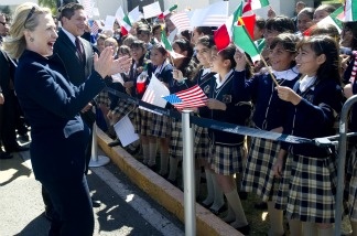 US Secretary of State Hillary Clinton greets Mexican school children upon arrival at Guanajuato International Airport in Guanajuato, Mexico, on Janu. 24, 2011. Clinton traveled to Mexico on a one-day trip for meetings with Mexican Foreign Minister Patricia Espinosa on border security and drug trafficking.