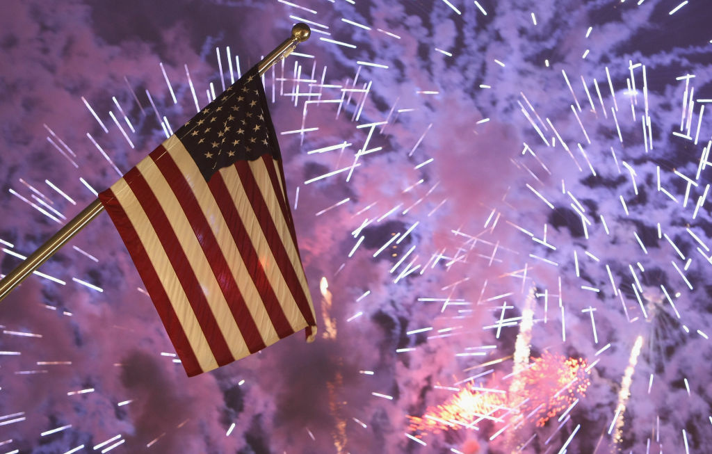 Opening Of New U.S. Embassy Fireworks explode behind the U.S. flag.