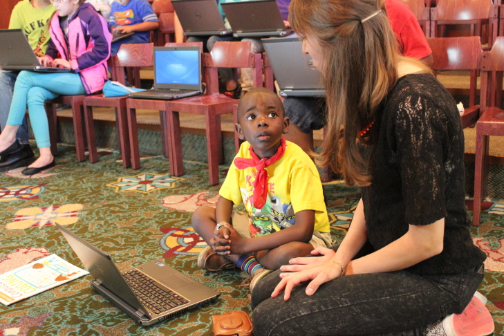 Children’s librarian Brooke Sheets (center) uses colored cups to teach algorithms and debugging to a group of girls at a computer science fair at L.A.'s downtown Central Library