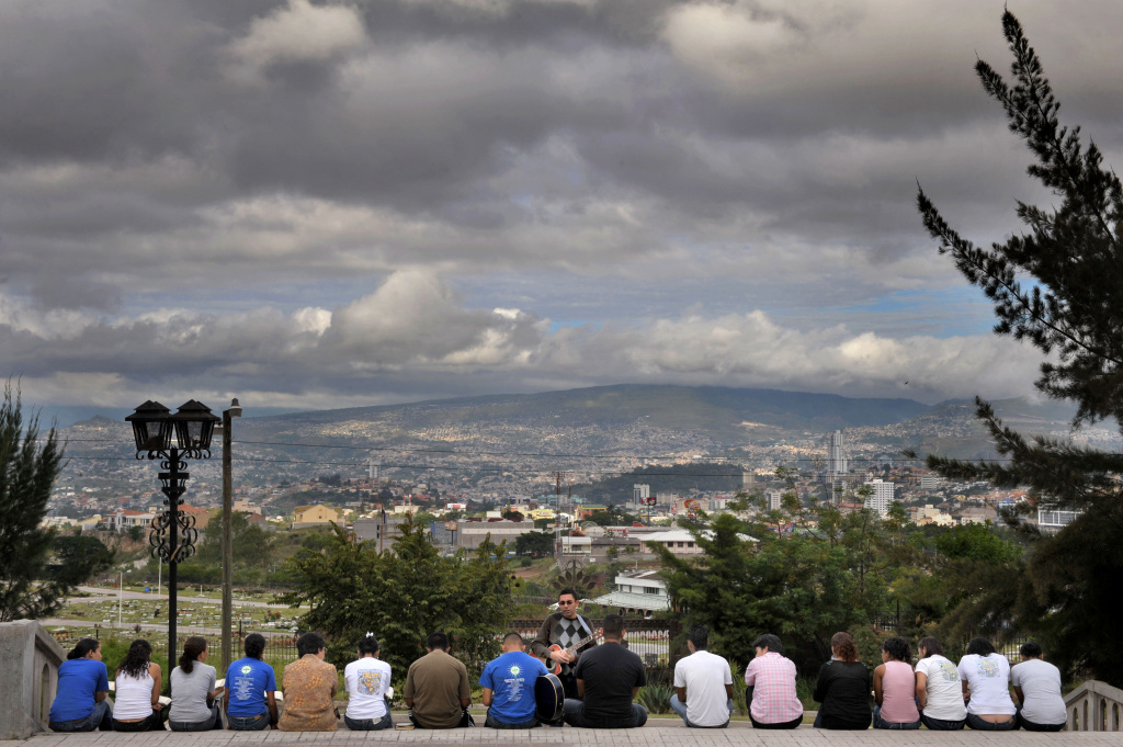 A group of youths studies the Bible, at A group of youths studies the Bible, at the steps of the Suyapa Virgin basilica, in Tegucigalpa, Honduras, on October 3, 2009.