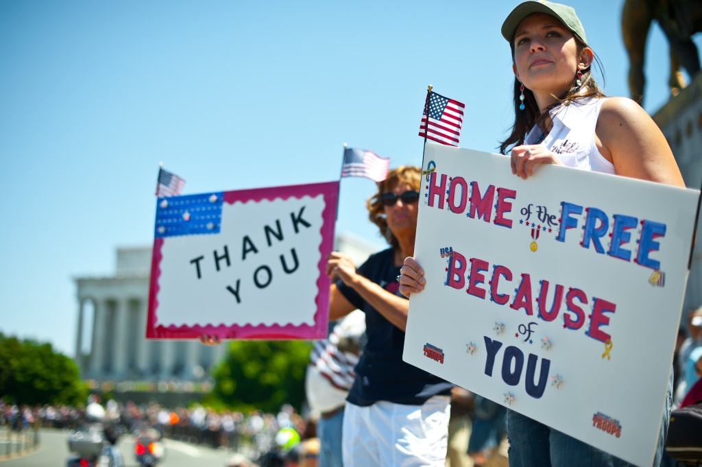 Thanking vets Two women hold up signs thanking the troops as members of the US military veterans' Rolling Thunder bikers group ride past in Washington on May 26, 2013 as the country marks Memorial Day.