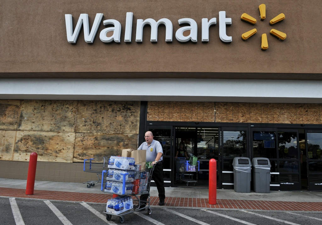 A man walks out of a boarded up Walmart A man walks out of a boarded up Walmart store with a cart full of bottled water and other supplies in Kitty Hawk in the North Carolina Outerbanks on August 26, 2011 ahead of the expected landfall in the area of Hurricane Irene. Millions of people on the US east coast braced for the hurricane, a massive storm officials fear will cause widespread flooding and dangerous conditions up the seaboard. Officials from North Carolina to New York declared states of emergency as tens of thousands of the most vulnerable residents were ordered to higher ground as Irene raced toward the US mainland. AFP PHOTO/Nicholas KAMM (Photo credit should read NICHOLAS KAMM/AFP/Getty Images)