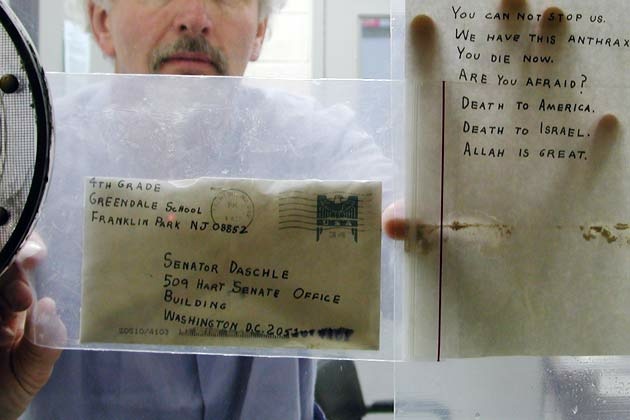 A U.S. Army scientist holds up one of the anthrax letters.