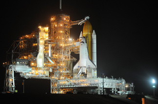 The US space shuttle Discovery is seen after the rotating service structure (L) is moved away February 23, 2011 at Kennedy Space Center in Florida as preparations are made for a February 24 launch.