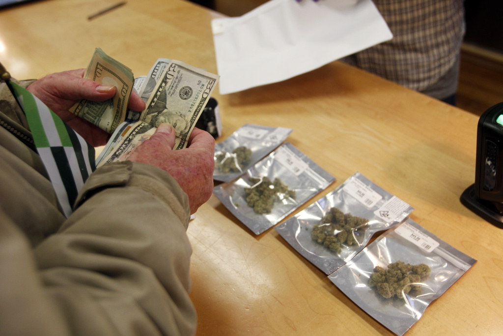 APTOPIX California Marijuana-Open for Business A customer purchases marijuana at Harborside marijuana dispensary, Monday, Jan. 1, 2018, in Oakland, Calif.