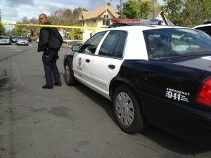 An officer at the scene of the double murder of two University of Southern California students in Los Angeles' West Adams neighborhood, April 11, 2012