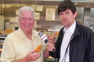 Mercer 19272 Huell Howser (with donut) and KPCC's John Rabe.
