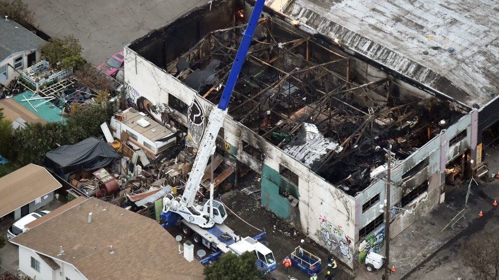 A crane is used to lift wreckage as part of search efforts in a fire-ravaged warehouse on December 5, 2016, in Oakland, Calif. A crane is used to lift wreckage as part of search efforts in a fire-ravaged warehouse on December 5, 2016, in Oakland, Calif.
