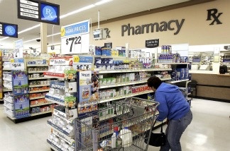 Mercer 18571 A woman shops in the pharmacy area of a Wal-Mart store.