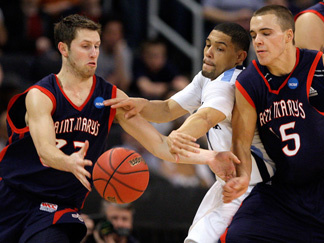 Villanova's Scottie Reynolds, center, fights through a screen by Saint Mary's Beau Levesque, right, to disrupt a dribble by Saint Mary's Mickey McConnell, left, during the first half of Saint Mary's 75-68 NCAA tournament victory.