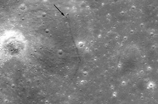 This photo from NASA's Lunar Reconnaissance Orbiter shows the Lunkokhod 2 rover's resting place. The black arrow indicates where the tracks begin — the white arrow and dot shows the rover. Arrows placed by Phil Stooke, geography professor at University of Western Ontario.