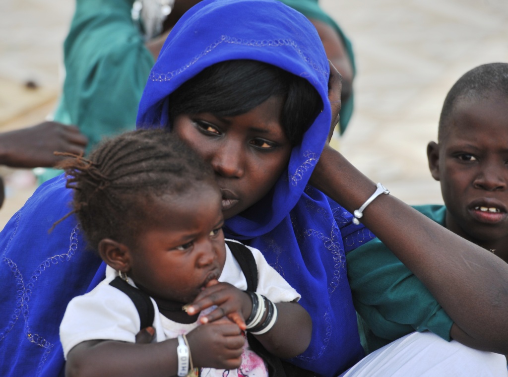 A women sits with her daughter A woman sits with her daughter in Touba, a central region of Senegal.