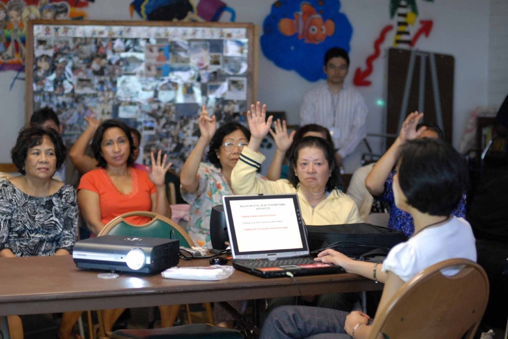 Khmer Rouge ruling Leakhena Nou, a sociology professor at Cal State, Long Beach, guides survivors of the Khmer Rouge through how to give a written testimony in this photo taken in 2010.