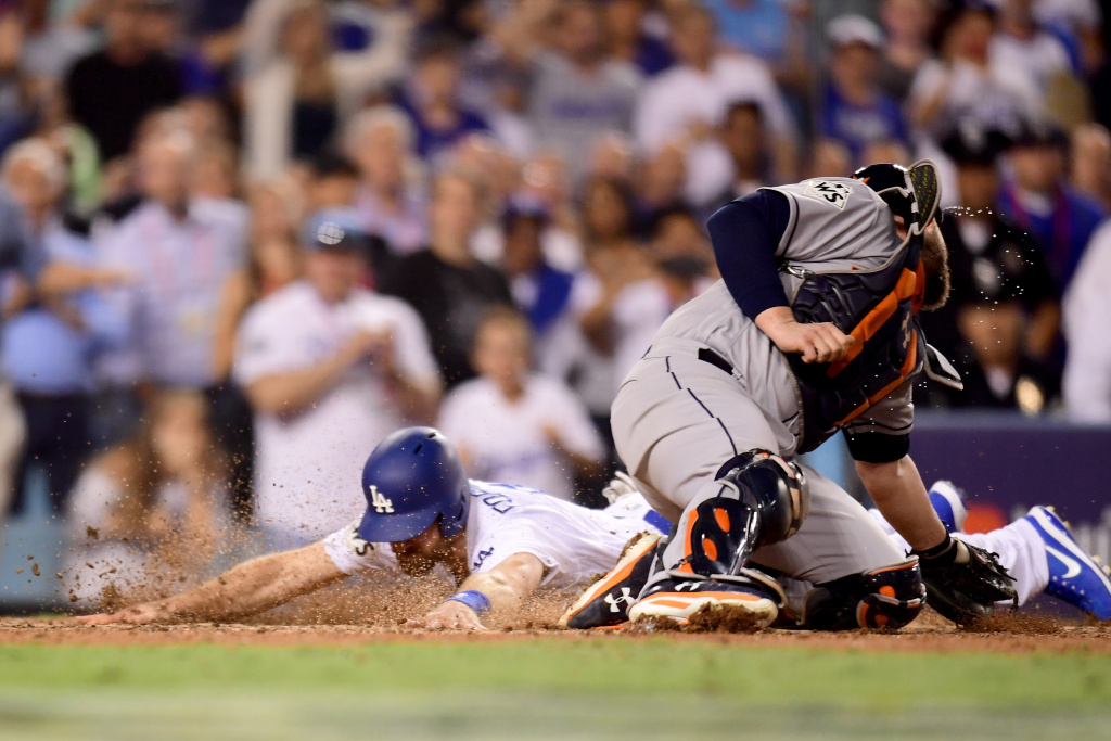 World Series - Houston Astros v Los Angeles Dodgers - Game Two Logan Forsythe of the Los Angeles Dodgers scores a run on a RBI single hit by Enrique Hernandez (not pictured) to tie the game 5-5 during the tenth inning.