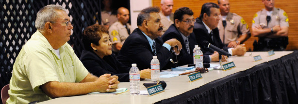 (L-R) City of Bell council members Lorenzo Velez, vice mayor Teresa Jacobo mayor Oscar Hernandez, coucilmen George Mirabel, and Luis Artiga, listen to residents asking them to resign during a council meeting on July 26, 2010 in Bell, California. The council members have voted to cut their salaries in response to public outcry at city officials' high salaries.