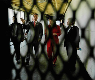 California Gov Arnold Schwarzenegger, second from left, tours a prison with officials, Tuesday, March 6, 2007, in Norco, Calif.