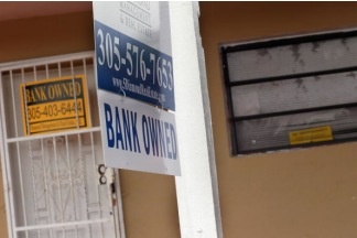 A bank owned sign hangs in front of a foreclosed home on October 14, 2010 in Miami, Florida. Bank repossessions rose to their highest level in September, exceeding 100,000 in a month for the first time, according to foreclosure tracker RealtyTrac.