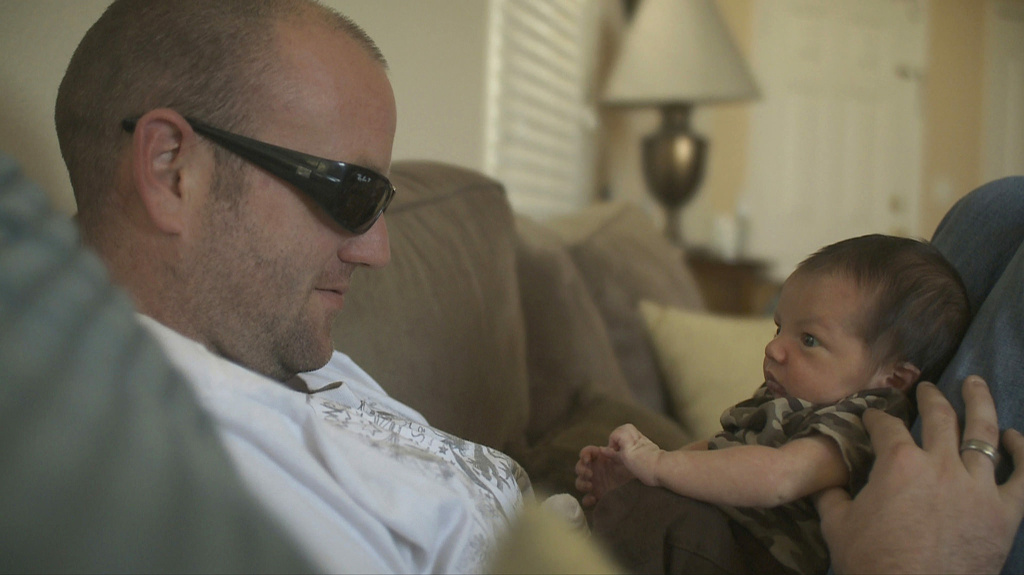 Veteran, Of Men and War A veteran and his newborn son, in a scene from the PBS film, Of Men and War. (Photo courtesy of Alice Films.)