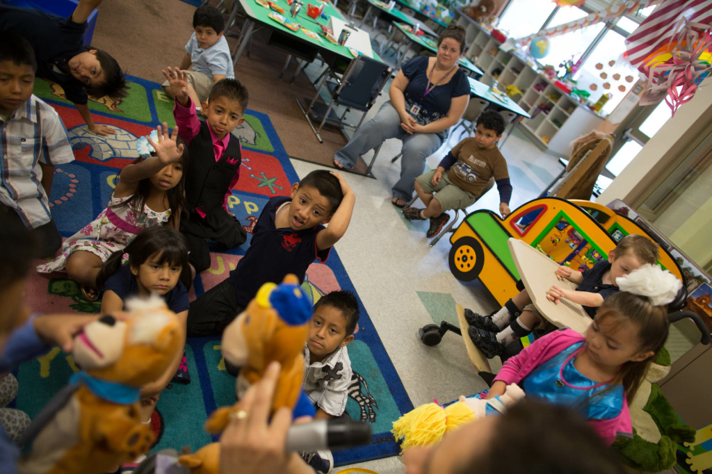 Transitional Kindergarten Students prepare to read a story with their teacher at the end of a year of classes at Stanley Mosk Elementary School.