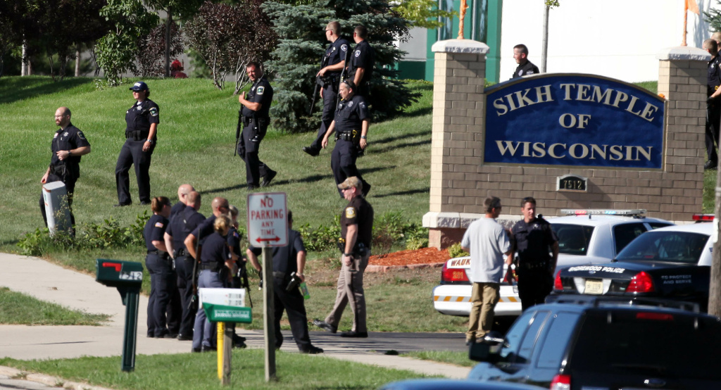 Law enforcement personnel walk outside t