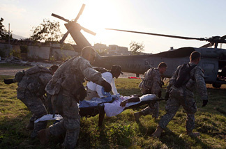 U.S. Army soldiers from the 82nd Airborne carry an injured women to an awaiting Navy helicopter as they medivac her after she was injured during the earthquake to the USNS Comfort on January 23, 2010 in Port-au-Prince, Haiti. Supplies and medical help continue to arrive as governments and aid agencies launch the massive relief operation after a powerful earthquake killed tens of thousands.